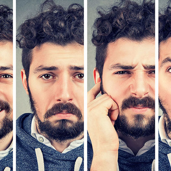 Un homme montre différentes expressions faciales