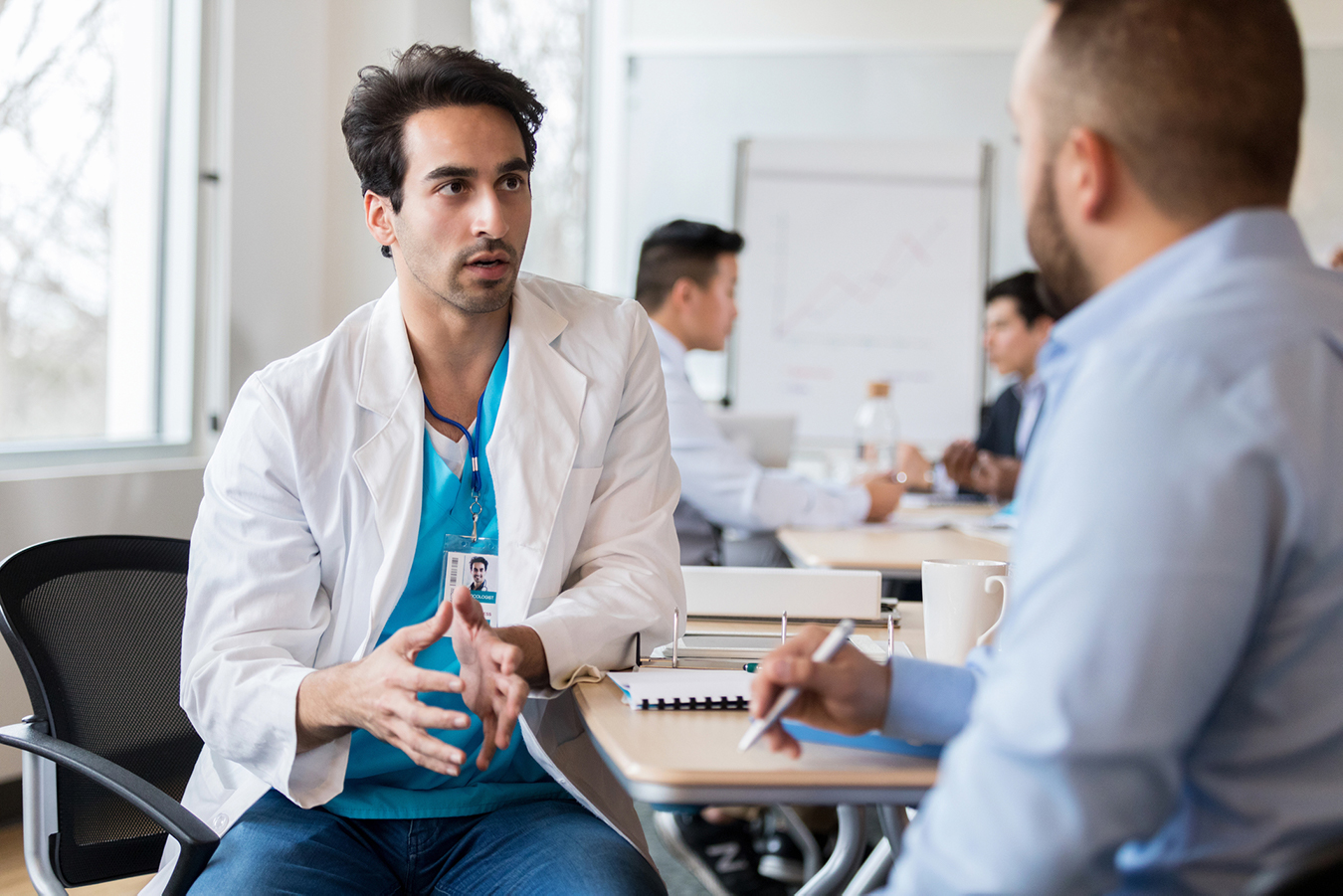 A supervisor gives feedback to a trainee.