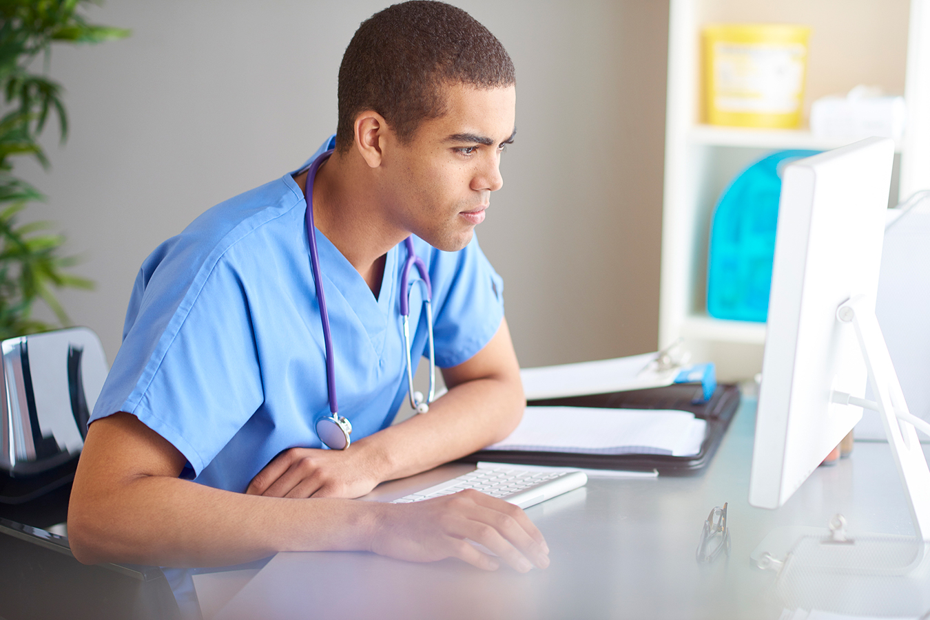 A trainee is looking at his computer.